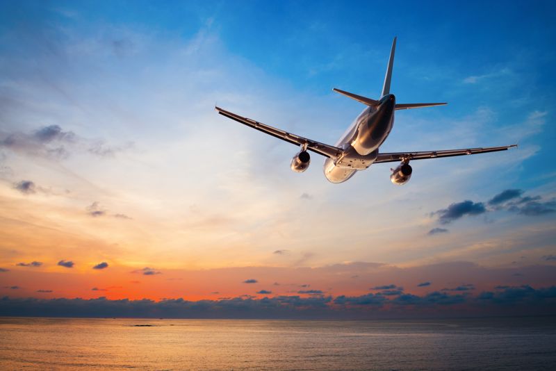 Airplane flying in the sky over water