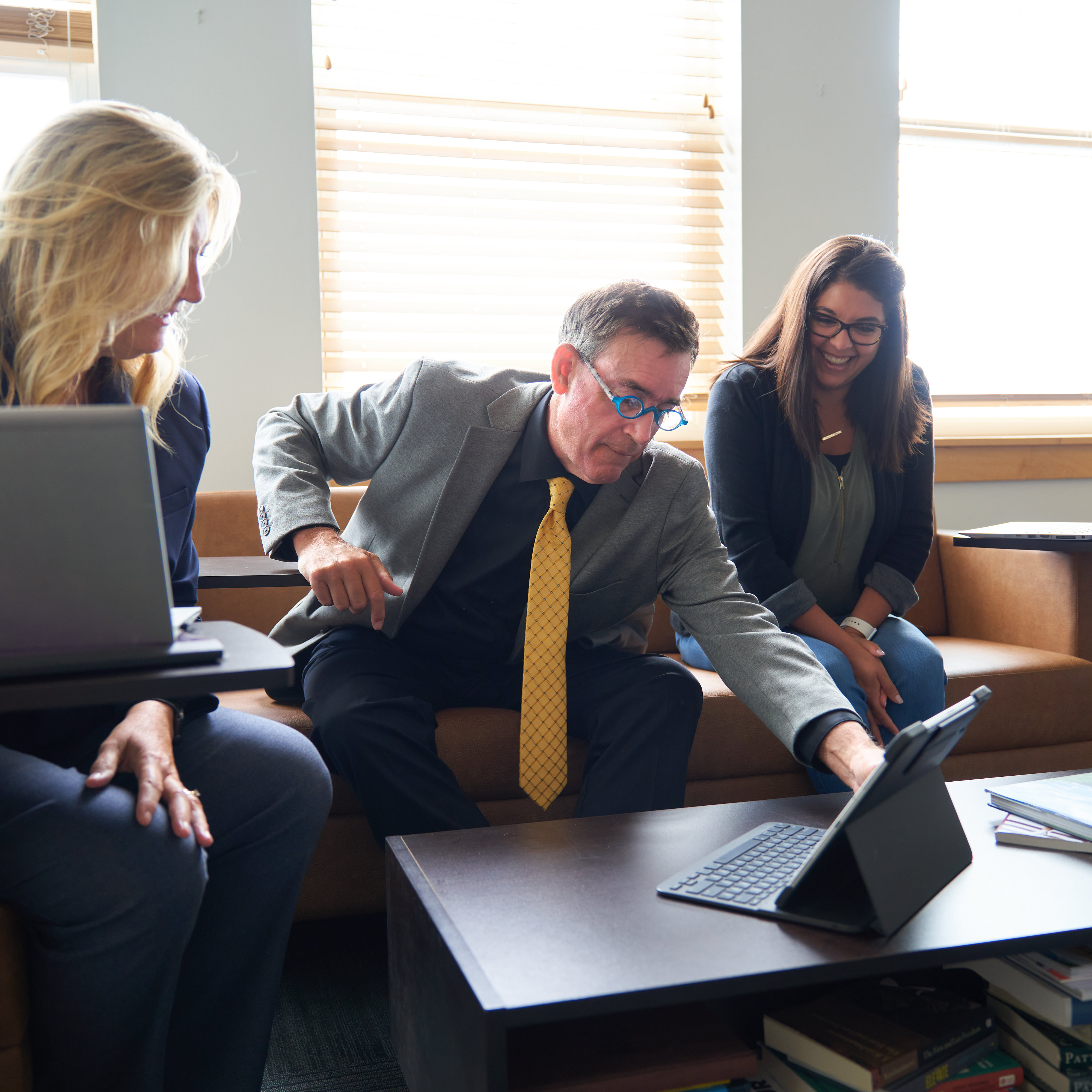 two women and a man in a meeting